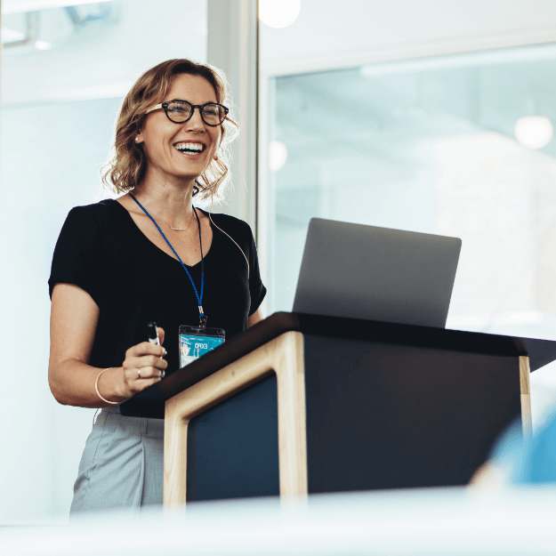 Businesswoman Standing at Podium