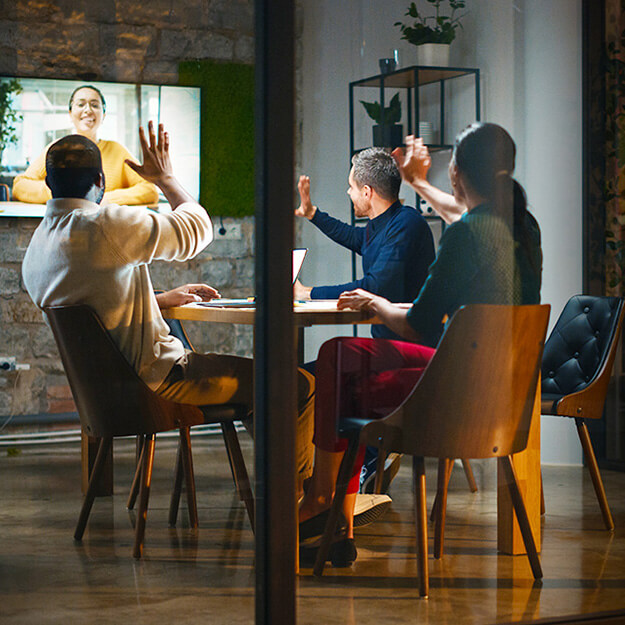 Coworkers Waving During Late Virtual Meeting